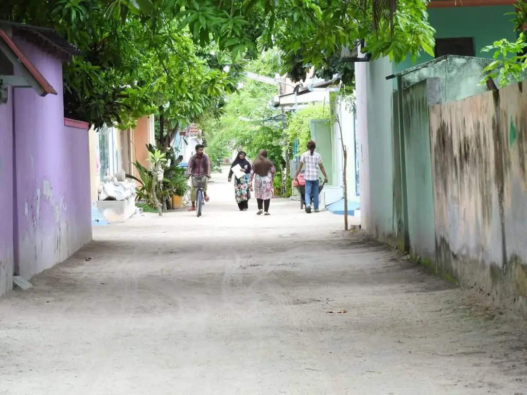 street of local island maldives showing local people -first time visit to Maldives