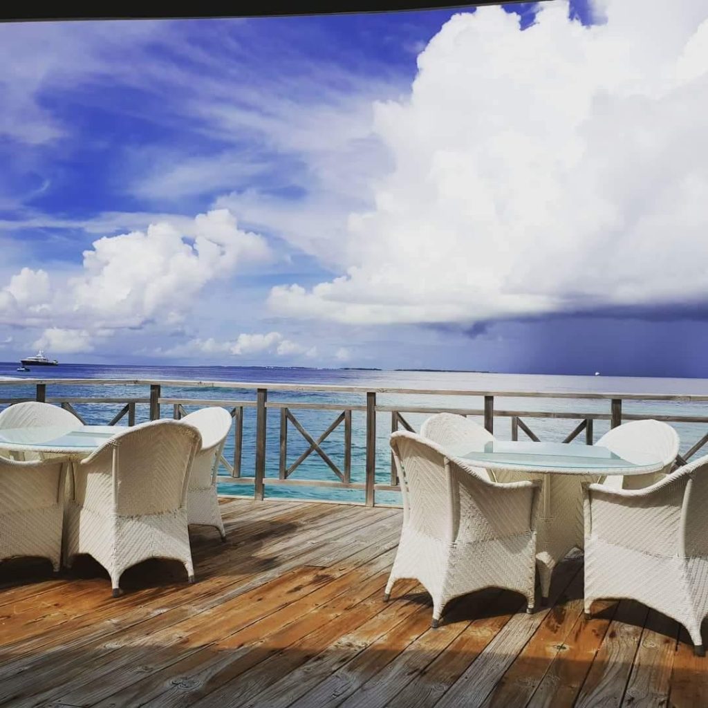 table and chairs overlooking the water -first time visit to Maldives