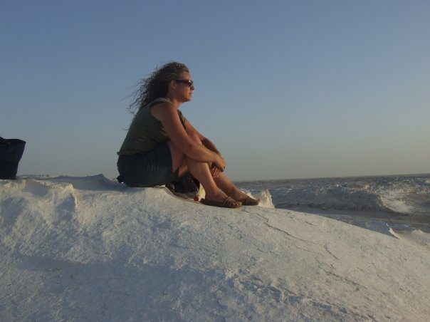 sitting in the white desert looking outward to the white desert landscape.Egypt experiences 