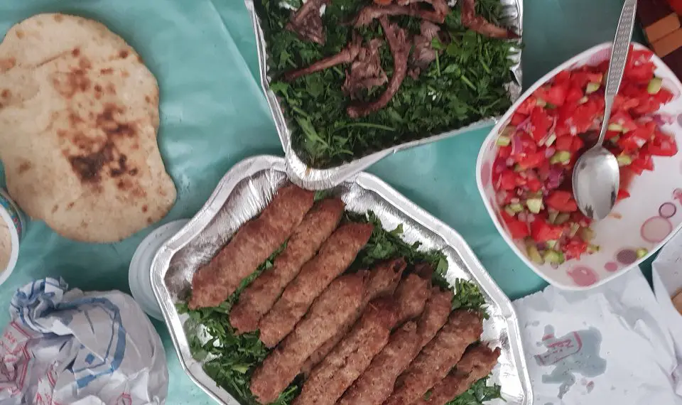 Egyptian food of salad, kofta and flat bread