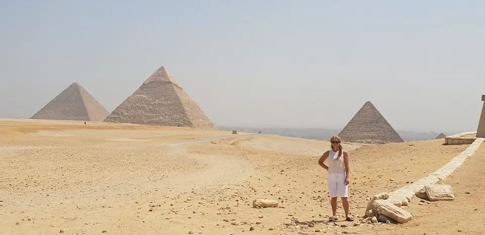 view of the pyramids shows 3 pyramids with myself standing in the foreground in all white