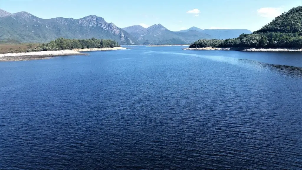 large fresh water lake with mountains in the background