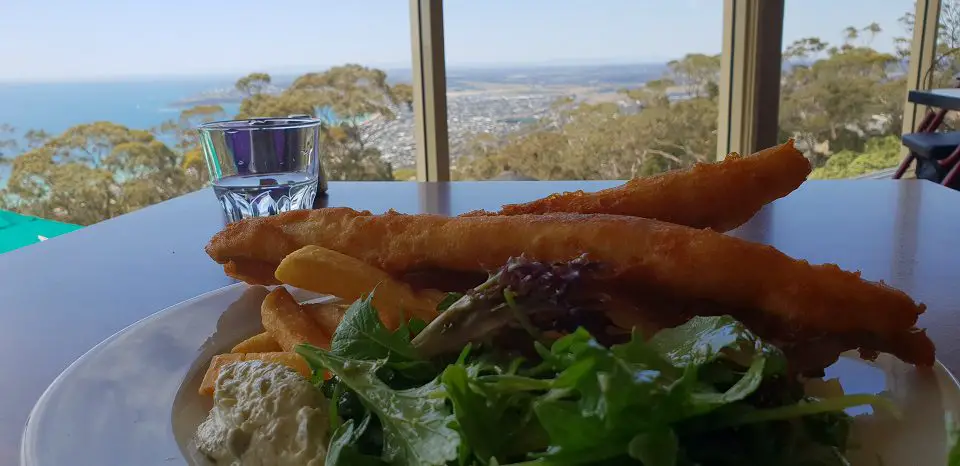Mornington Peninsula day trip - a meal of fish and salad with views of the bay through the windows in front